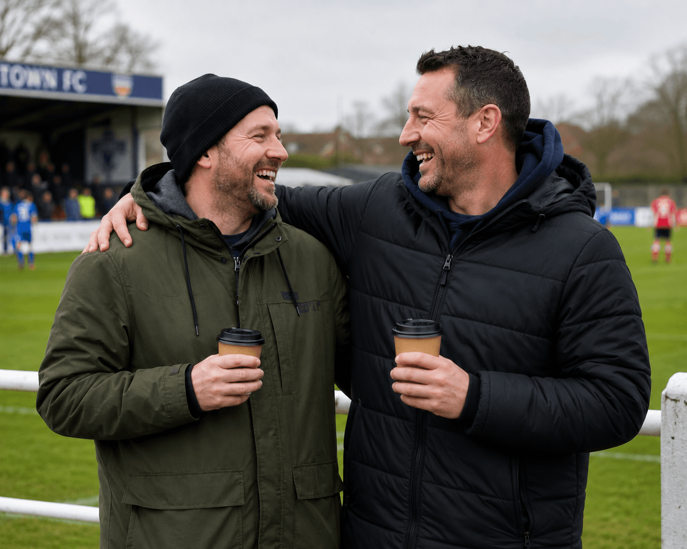 Two mates sharing a laugh over coffee at the footy